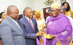 L-R: Executive Lagos State Governor, Mr. Akinwunmi Ambode; President/CE, Dangote Group, Aliko Dangote; Lagos State Commissioner for Women Affairs and Poverty Alleviation, presenting the grant to Mrs. Lola Akande; a beneficiary, Mrs. Idowu Alenimadehin from Epe; during The Official flag-off of the Dangote Foundation Micro Grant Scheme for Women in LGAS/LCDAS on Thursday, 26th May, 2016 in Lagos.