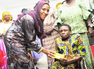 L-R: Executive Director, Dangote Group, Halima Aliko Dangote; presenting the grant to a physically challenged beneficiary, Kaosara Fagbemi from Surulere, during The Official flag-off of the Dangote Foundation Micro Grant Scheme for Women in LGAS/LCDAS on Thursday, 26th May, 2016 in Lagos.